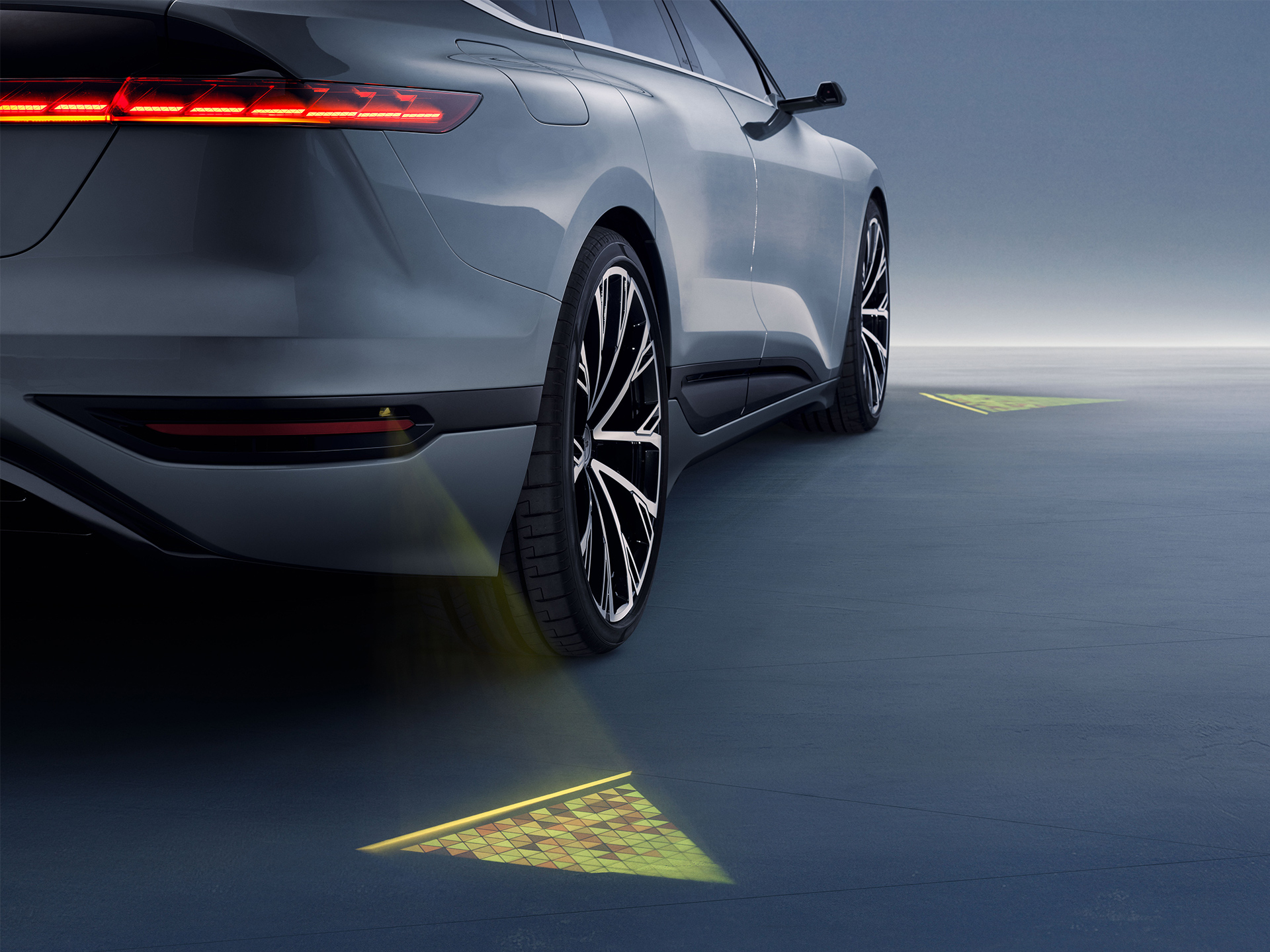 LED projectors on the vehicle create glowing triangles on the ground. 